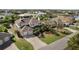 An aerial view showcasing a two-story house with a two car garage and lush landscaping at 9458 Snapper Cir, Port Charlotte, FL 33981