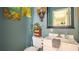 Small bathroom with white vanity, toilet, and decorative wall art at 9458 Snapper Cir, Port Charlotte, FL 33981