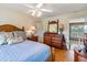 Spacious bedroom with wood floors and large dresser at 9458 Snapper Cir, Port Charlotte, FL 33981