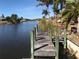 Private wooden dock extending over calm canal waters at 9458 Snapper Cir, Port Charlotte, FL 33981