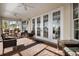 Relaxing covered patio with wicker furniture and ceiling fan at 9458 Snapper Cir, Port Charlotte, FL 33981