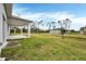 Spacious backyard with covered patio and green space at 99 Sundiet St, Port Charlotte, FL 33954