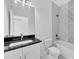 Bathroom with single vanity, tub, and marble-look walls at 99 Sundiet St, Port Charlotte, FL 33954