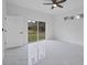 Bright bedroom with ceiling fan, marble-look floors, and sliding glass doors at 99 Sundiet St, Port Charlotte, FL 33954