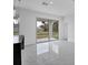 Bright dining area with marble-look floors and sliding glass doors leading outside at 99 Sundiet St, Port Charlotte, FL 33954