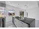 Modern kitchen featuring white cabinets, a large island, and black countertops at 99 Sundiet St, Port Charlotte, FL 33954