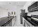 Modern kitchen with stainless steel appliances and dark countertop at 99 Sundiet St, Port Charlotte, FL 33954