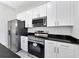 Modern kitchen with stainless steel appliances and white cabinets at 99 Sundiet St, Port Charlotte, FL 33954