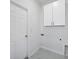 Laundry room with white cabinets and marble-look floors at 99 Sundiet St, Port Charlotte, FL 33954