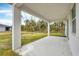 Covered patio overlooking backyard with green space at 99 Sundiet St, Port Charlotte, FL 33954