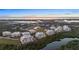 Aerial view of condo building and surrounding area at sunset at 10501 Amberjack Way # 101, Englewood, FL 34224