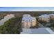 Aerial view showcasing the condo building's beautiful architecture surrounded by lush scenery at 10501 Amberjack Way # 101, Englewood, FL 34224