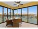 Enclosed balcony provides dining area with beautiful view and ceiling fan at 10501 Amberjack Way # 101, Englewood, FL 34224