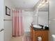 Bathroom featuring a vanity with granite countertop and a bathtub with shower at 10501 Amberjack Way # 101, Englewood, FL 34224