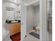 Bathroom featuring a walk-in shower, toilet, and vanity with a black countertop at 10501 Amberjack Way # 101, Englewood, FL 34224