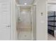 Bathroom featuring walk-in shower with glass enclosure and a bench seat at 10501 Amberjack Way # 101, Englewood, FL 34224