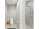 Bathroom featuring toilet and walk-in shower with gray tile surround at 10501 Amberjack Way # 101, Englewood, FL 34224