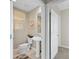 Powder room with pedestal sink and toilet at 10501 Amberjack Way # 101, Englewood, FL 34224
