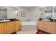 Large bathroom with double sinks and a soaking tub at 10501 Amberjack Way # 101, Englewood, FL 34224