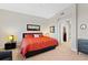 This bedroom features a modern design, carpeted floors and ensuite bathroom at 10501 Amberjack Way # 101, Englewood, FL 34224