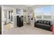 Carpeted bedroom with a couch, dresser and windows, providing a tranquil space at 10501 Amberjack Way # 101, Englewood, FL 34224