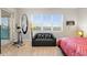 Cozy bedroom featuring a modern couch, fitness equipment, and bright windows at 10501 Amberjack Way # 101, Englewood, FL 34224