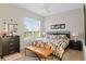Bedroom featuring floral bedding, ceiling fan, and plenty of natural light at 10501 Amberjack Way # 101, Englewood, FL 34224