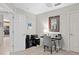 This bright bedroom features neutral walls, a desk area, and a view into the kitchen, offering a flexible living space at 10501 Amberjack Way # 101, Englewood, FL 34224