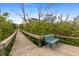 Scenic boardwalk with a charming bench amidst lush greenery, creating a peaceful retreat at 10501 Amberjack Way # 101, Englewood, FL 34224