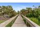 Scenic boardwalk surrounded by lush tropical vegetation, perfect for a relaxing walk at 10501 Amberjack Way # 101, Englewood, FL 34224
