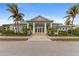 Charming clubhouse with a lushly landscaped entrance, offering an inviting space for community gatherings at 10501 Amberjack Way # 101, Englewood, FL 34224