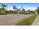 Gated community entrance with brick pavers and lush landscaping at 10501 Amberjack Way # 101, Englewood, FL 34224