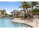 Resort-style community pool with inviting lounge chairs and tropical landscaping for relaxation at 10501 Amberjack Way # 101, Englewood, FL 34224