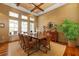 Community dining room with wood floors, large windows and table with seating for eight at 10501 Amberjack Way # 101, Englewood, FL 34224