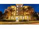 Condo building entrance at night, palm trees and landscaping at 10501 Amberjack Way # 101, Englewood, FL 34224