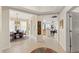Open-concept foyer with elegant decor, seamless flow into dining & kitchen, and tile flooring at 10501 Amberjack Way # 101, Englewood, FL 34224