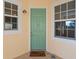 Charming exterior of unit 101 with a light green front door, white trim, and turtle decor at 10501 Amberjack Way # 101, Englewood, FL 34224