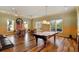 Community game room with billiard table, game tables, wood floors, and vintage ship decor at 10501 Amberjack Way # 101, Englewood, FL 34224
