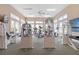 Bright fitness room equipped with multiple treadmills, weight machines, and large windows offering a sunny atmosphere at 10501 Amberjack Way # 101, Englewood, FL 34224