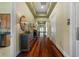 Hallway with hardwood floors and antique furniture at 10501 Amberjack Way # 101, Englewood, FL 34224