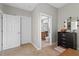 Hallway leading to the bathroom and a linen closet, carpeted floors and light paint at 10501 Amberjack Way # 101, Englewood, FL 34224