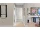 Hallway with tile floor leads to other rooms decorated with modern art and furniture at 10501 Amberjack Way # 101, Englewood, FL 34224