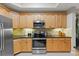 Updated kitchen with stainless appliances, granite counters, and plentiful wooden cabinetry at 10501 Amberjack Way # 101, Englewood, FL 34224
