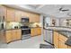 Well-lit kitchen with wood cabinets, granite countertops, stainless steel appliances, and modern fixtures at 10501 Amberjack Way # 101, Englewood, FL 34224