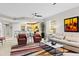 Open-concept living space with modern furniture and adjacent kitchen, perfect for entertaining at 10501 Amberjack Way # 101, Englewood, FL 34224
