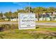Cape Haze Marina sign with palm trees; friendly, fun, and festive marina at 6950 at 10501 Amberjack Way # 101, Englewood, FL 34224