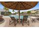 Relaxing poolside lounge area with shaded seating, providing a comfortable space to enjoy the pool at 10501 Amberjack Way # 101, Englewood, FL 34224