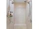 Close-up of dual shower heads with gray tile surround and a bench seat at 10501 Amberjack Way # 101, Englewood, FL 34224