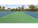 Community tennis courts with bench seating, net and fenced in for safety and privacy at 10501 Amberjack Way # 101, Englewood, FL 34224