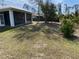 Large backyard with covered patio and fenced area at 1209 Nordendale Blvd, North Port, FL 34288